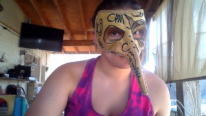 Girl wearing golden mask with pointed nose