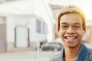Teenage boy smiling at the camera.
