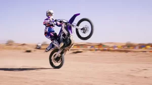 Dustin, a Primavera Online Student, riding a dirtbike.